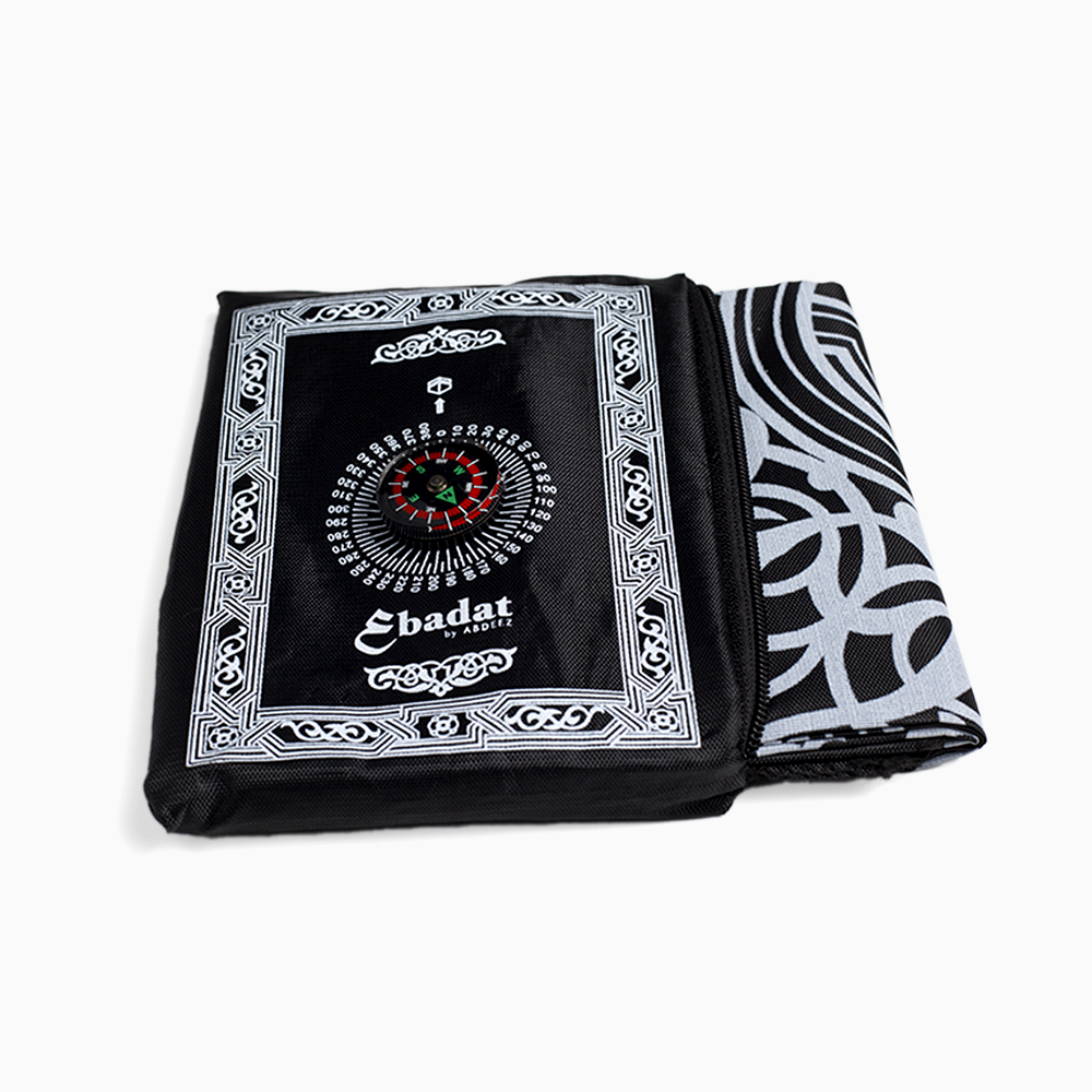 A black portable prayer mat by abdeez along with its pouch