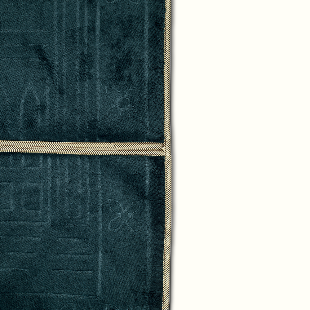 a close up view for a prayer rug in dark emerald green color