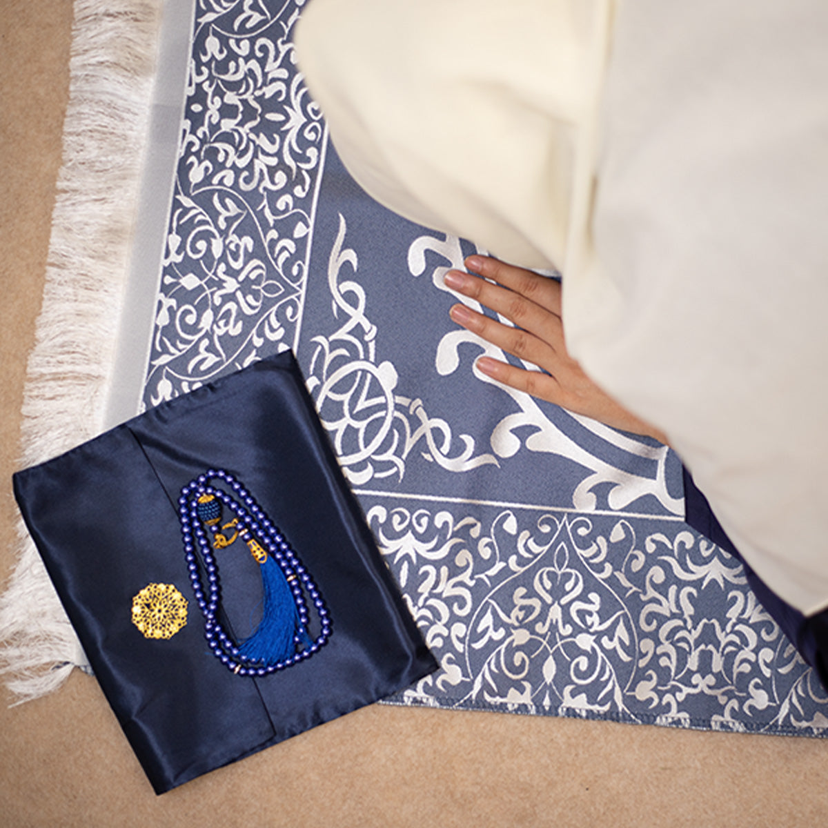 a woman praying on gift ebadat prayer mat in navy blue color