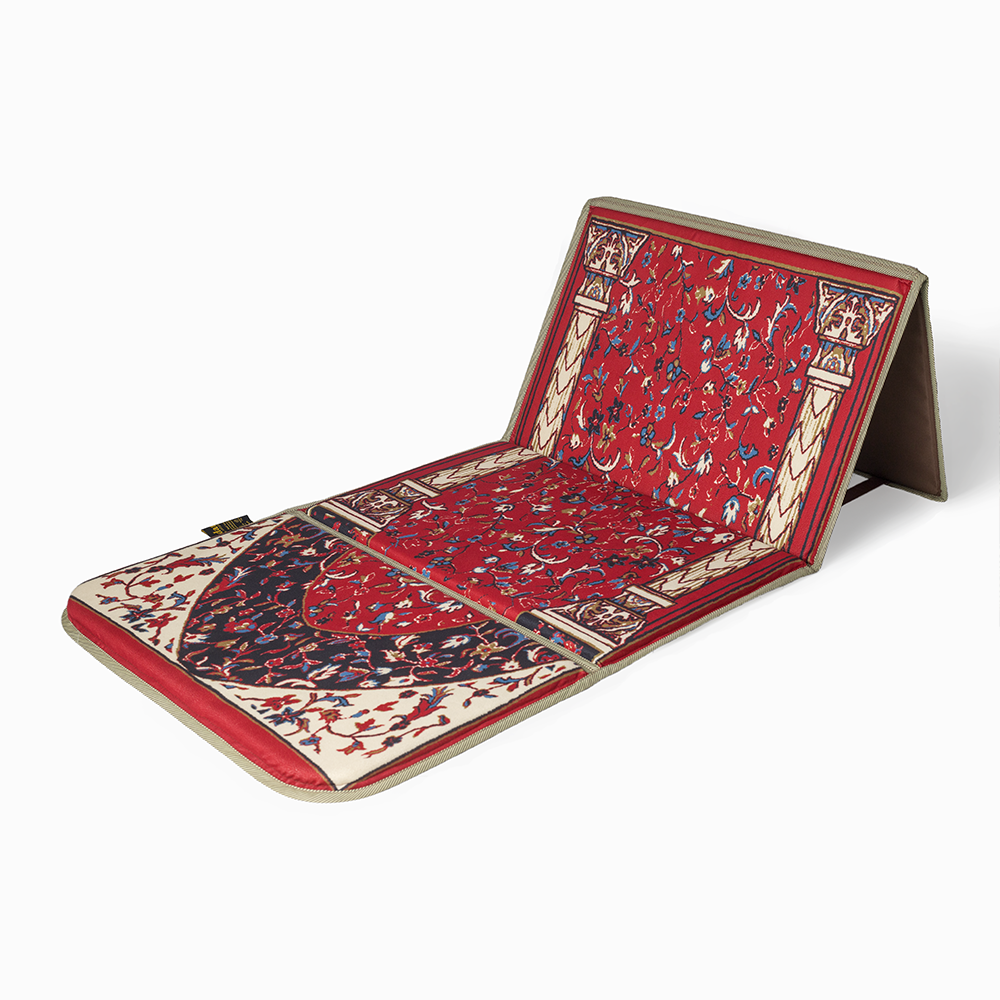 A lava red folded padded prayer rug with a geometric pattern, featuring a backrest.