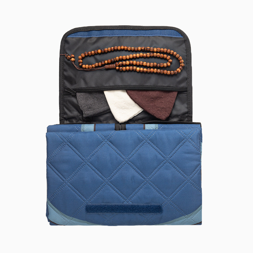 Portable prayer mat with built-in zipped pocket carrying prayer essentials