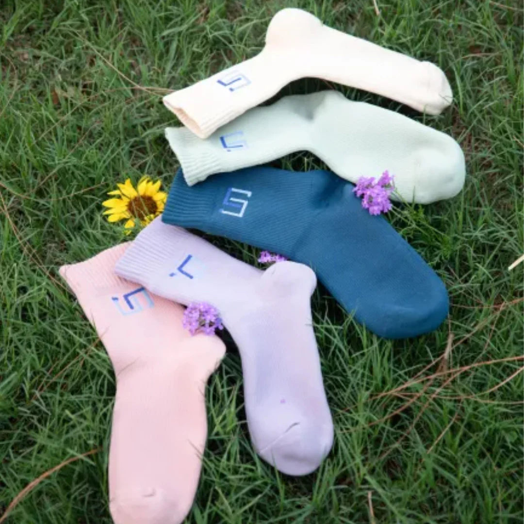 Colorful wudhu socks on a grassy background