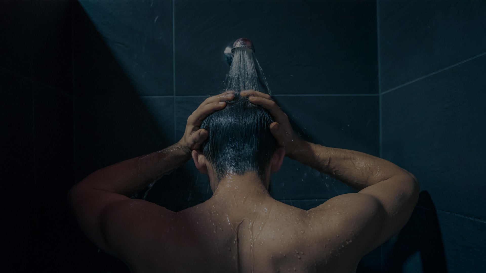 a man standing under the shower