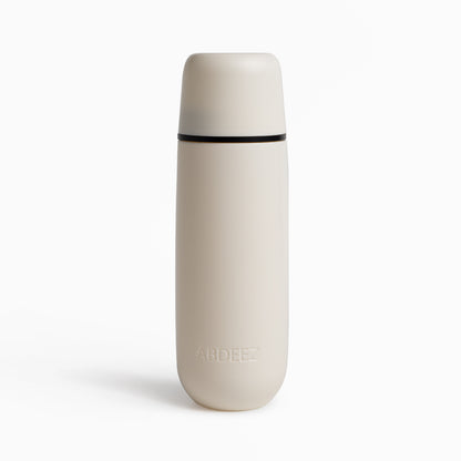 A beige portable bidet by ABDEEZ with a closed cap