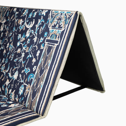 a midnight blue prayer rug with its backrest opened