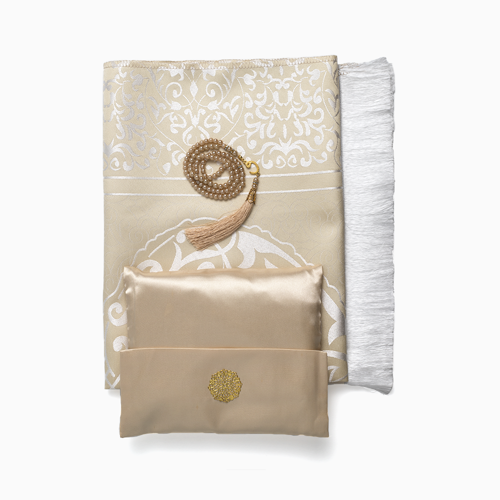 A set of prayer mat and prayer beads in beige color, displayed neatly on a white background.
