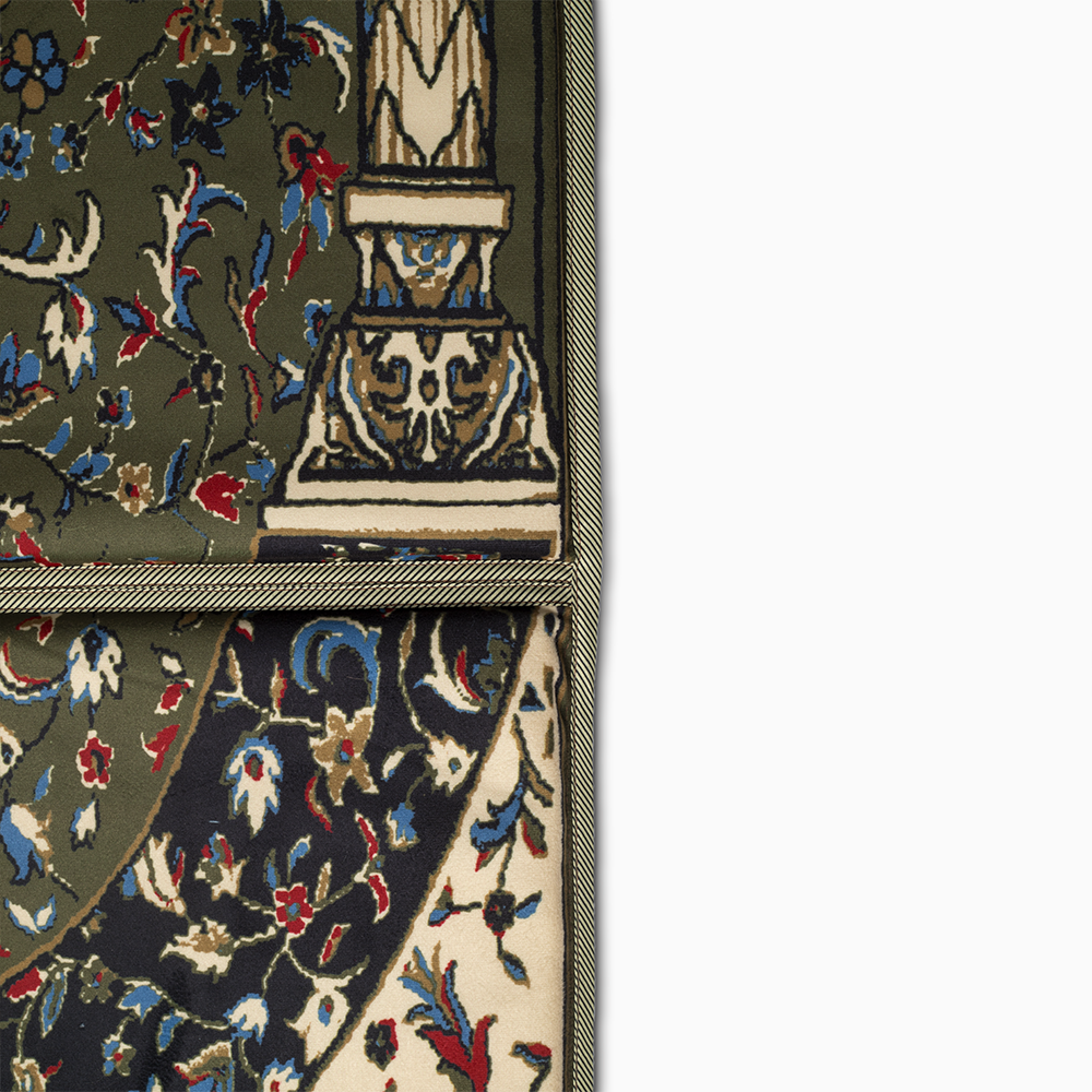 a close up view of green prayer rug