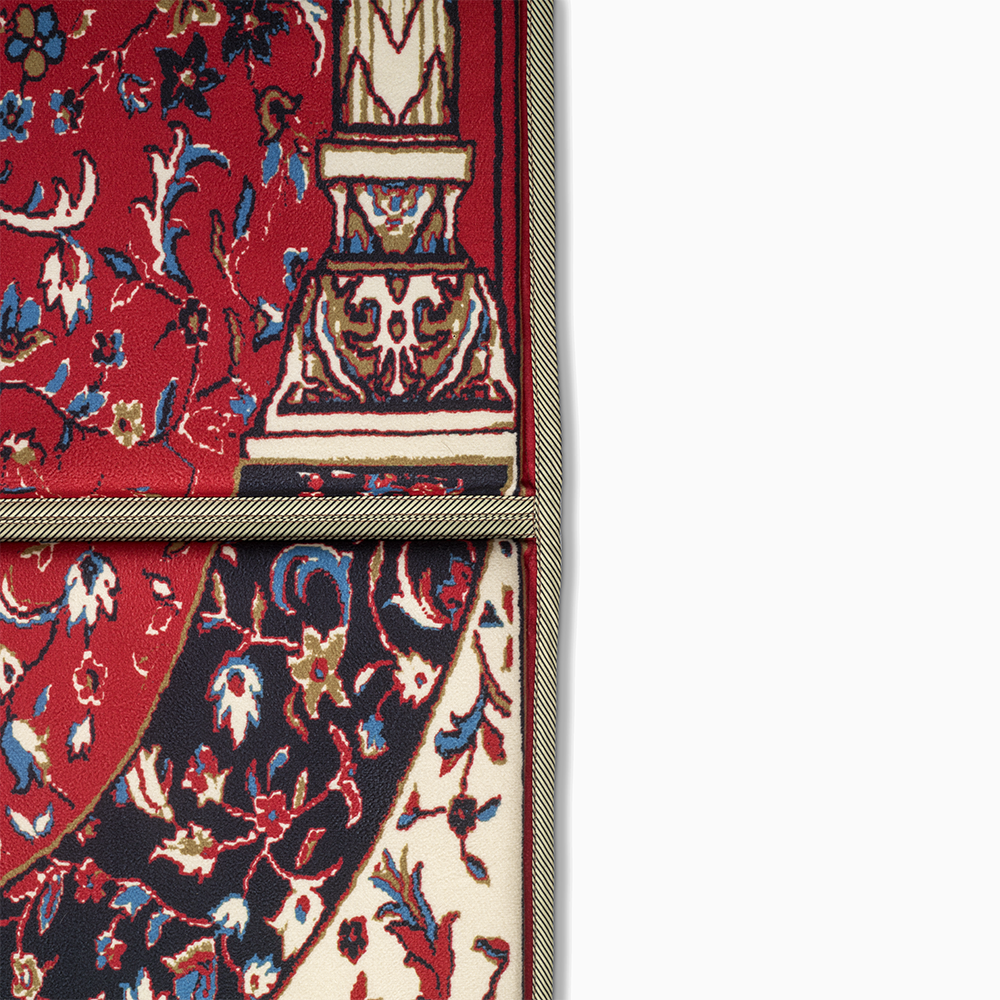 a close up view of lava red ebadat prayer rug