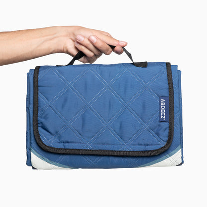 Blue prayer mat with a white patch held by a hand