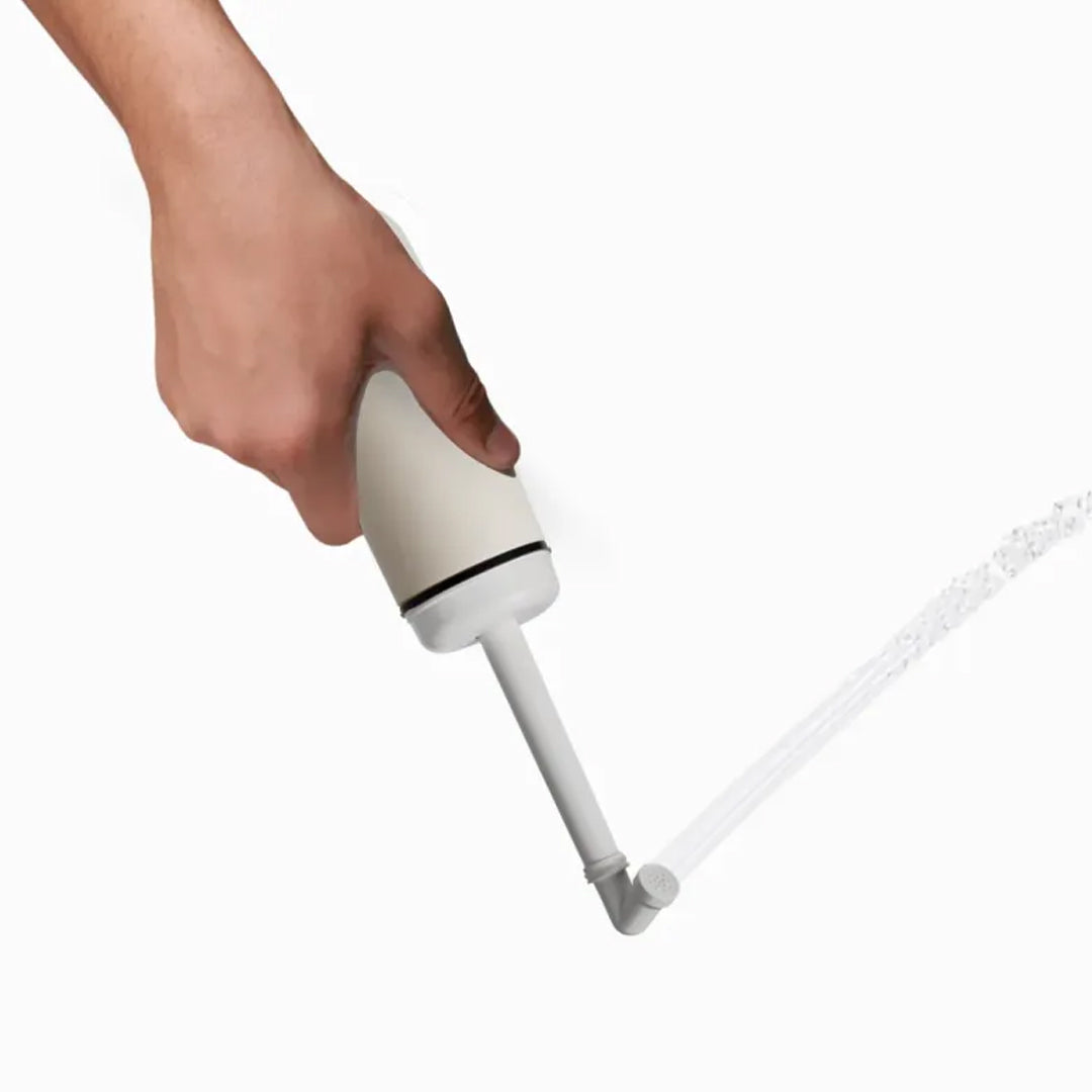 White portable bidet with water coming out of it's nozzle