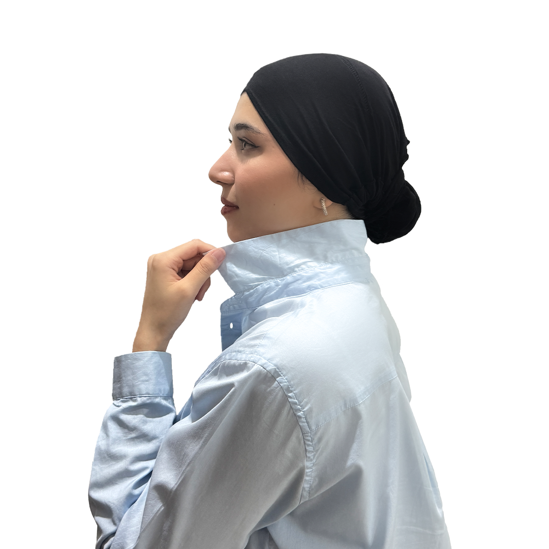 A woman wearing black underscarf cap