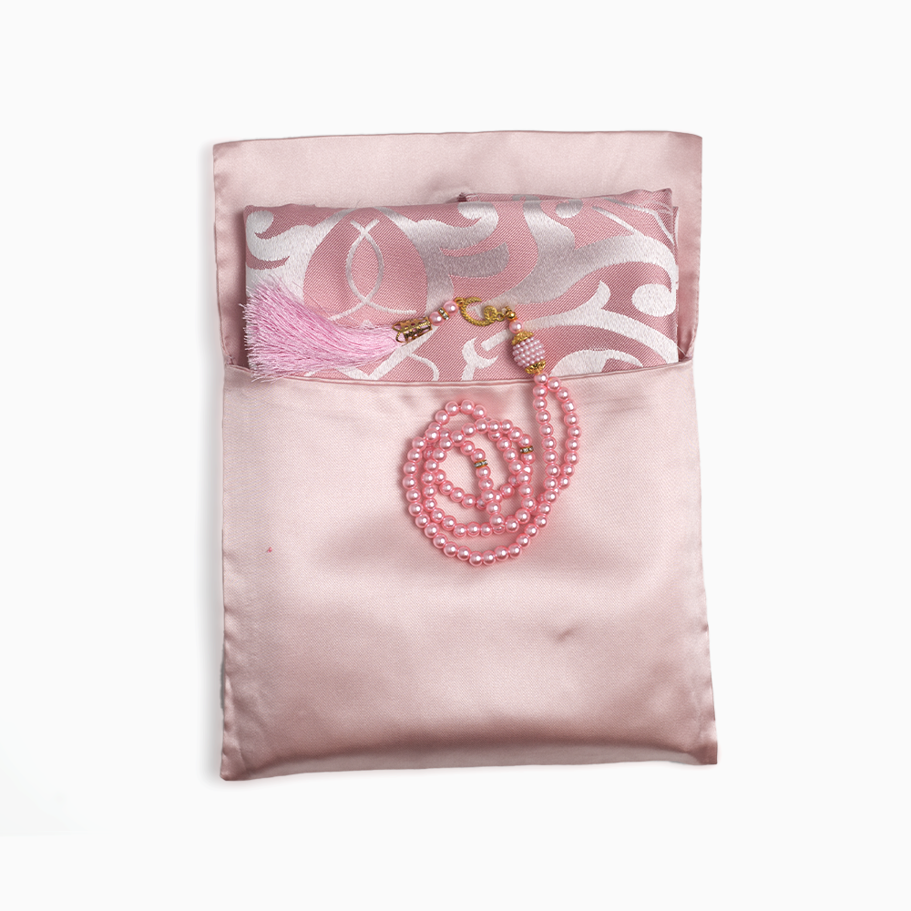 pink prayer mat placed inside its pouch and a pink prayer bead is placed over the pouch