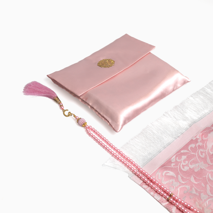 a pink prayer rug with its pouch and matching pink prayer bead
