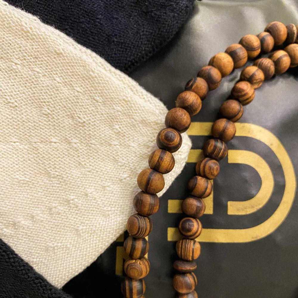 pink wudhu towel hanging via hook with tree in an outdoor setting