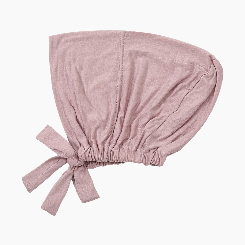 A pink underscarf made from high-quality, breathable cotton material with a tie-back closure