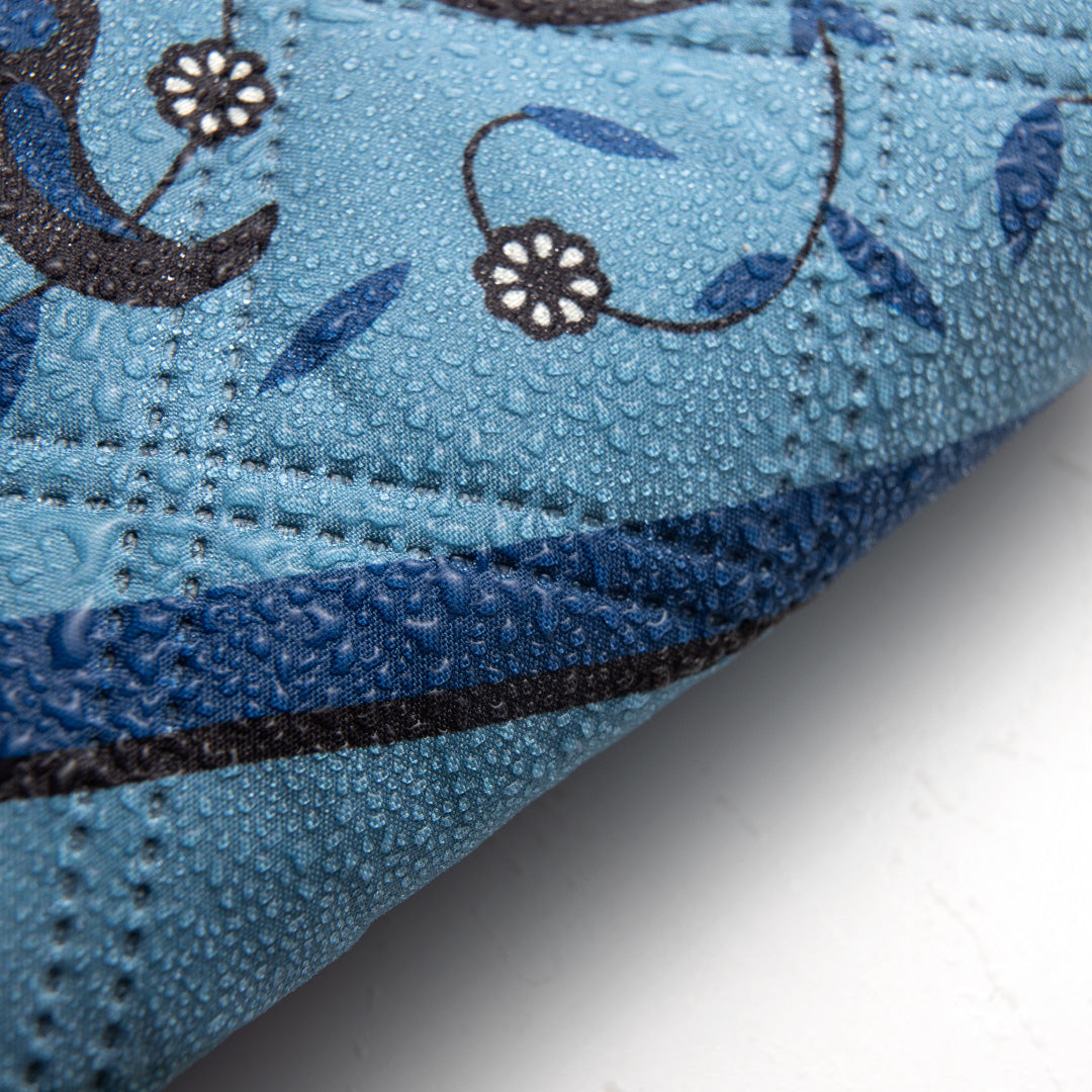 Close-up of a blue prayer mat with floral pattern
