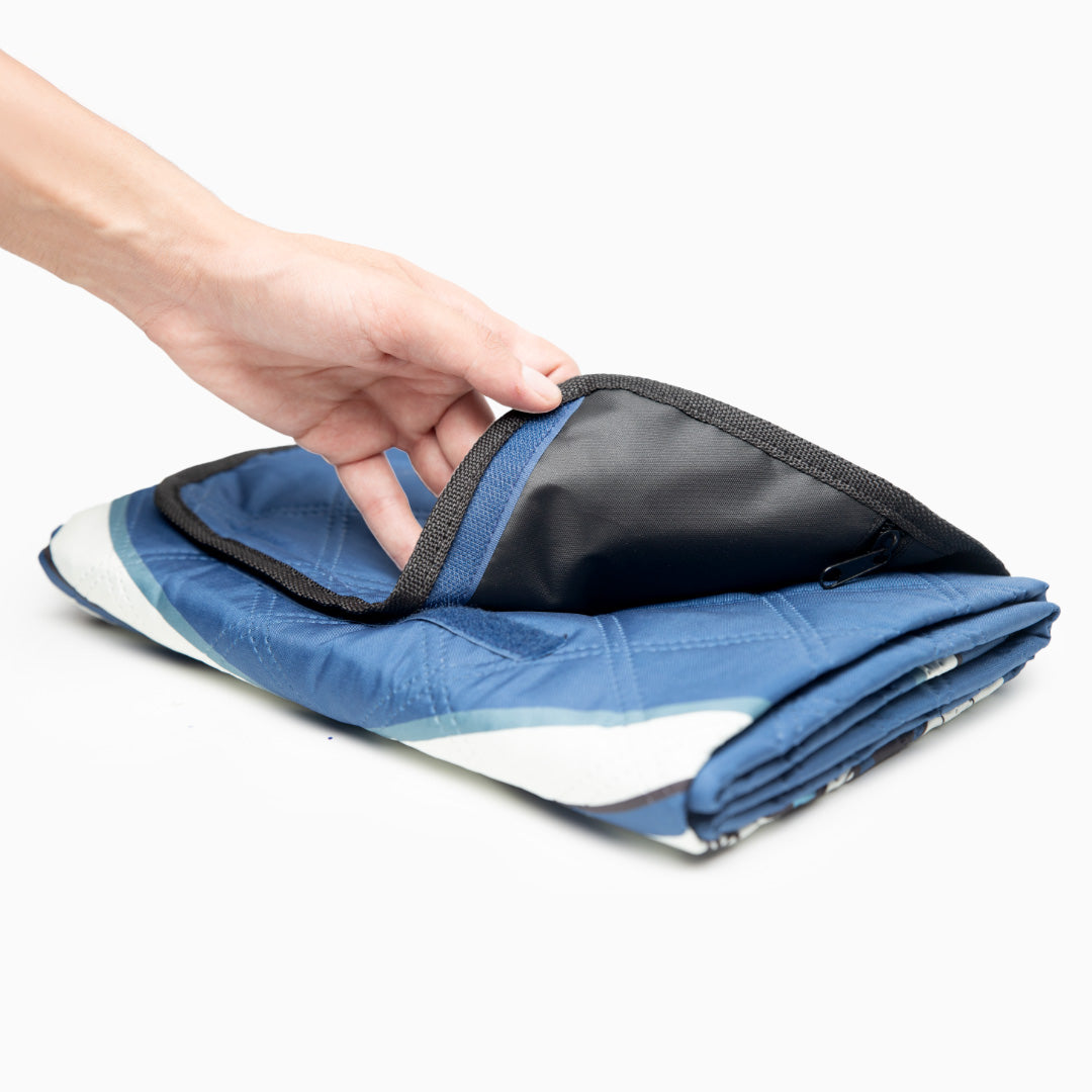 Person unfolding salahtrek prayer mat